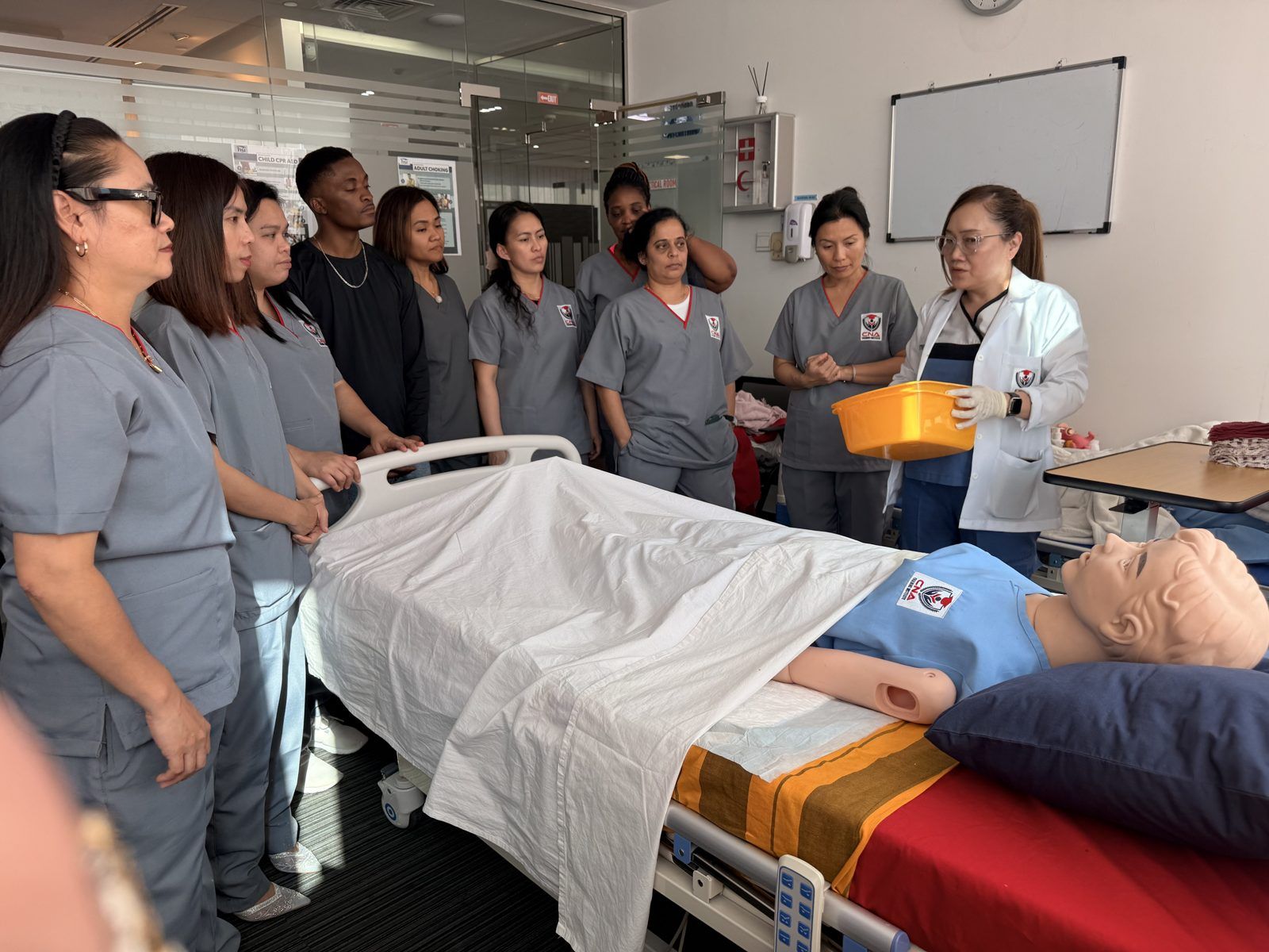 CNA students practicing CPR and AED use in a First Aid, CPR & Health Safety class